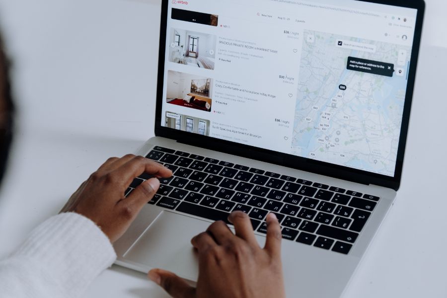 Person viewing an Airbnb listing on a Macbook