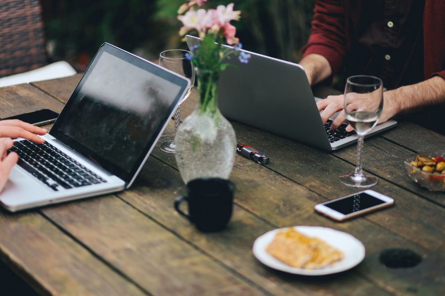 Co-Living Spaces - Two people working on laptops at the same table
