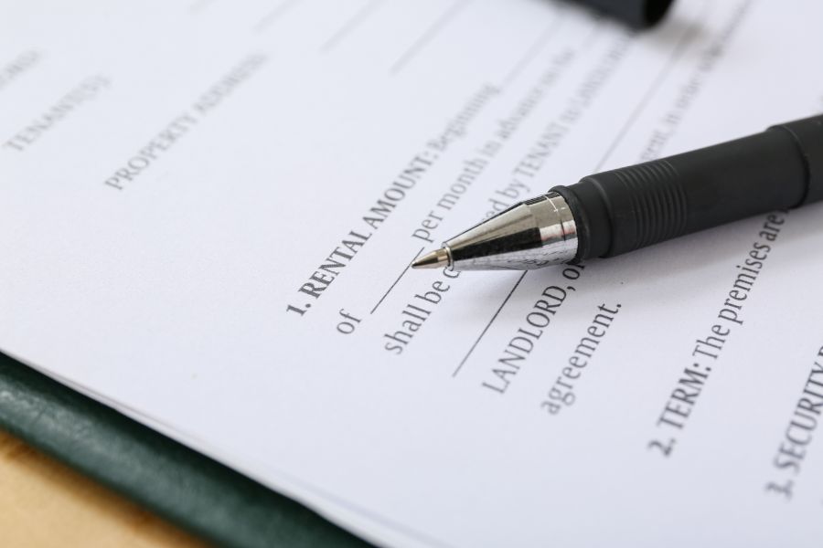 Rental agreement document with pen resting on top