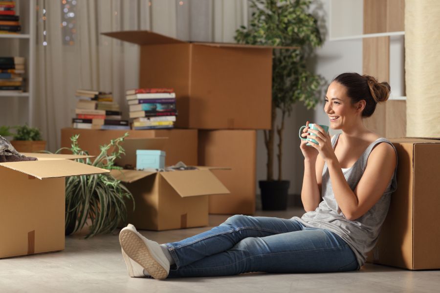 Satisfied Tenant Enjoying a Coffee surrounded by moving boxes